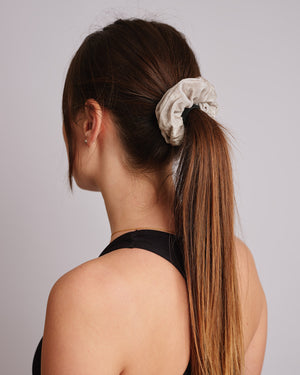 Neutral velvet scrunchie in a girls hair